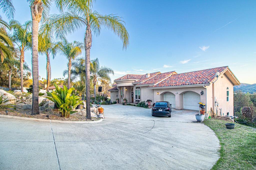 2057 Via Rancho Parkway Escondido, CA 92029 - Photo 5 of 56 a front view of a house with a yard