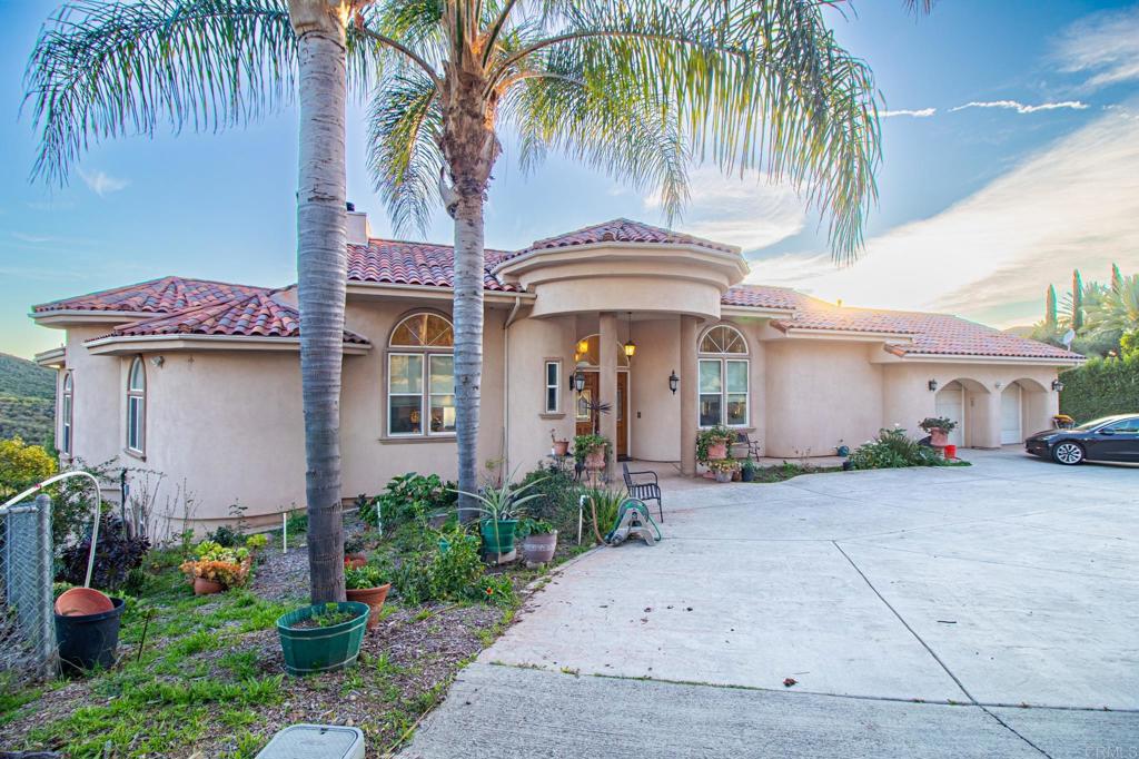 2057 Via Rancho Parkway Escondido, CA 92029 - Photo 6 of 56 a front view of a house with garden