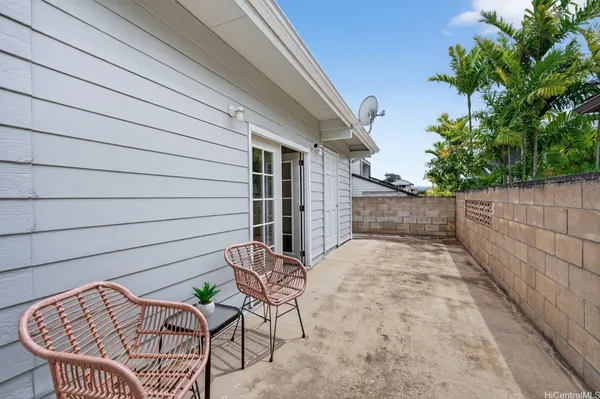 a backyard of a house with table and chairs