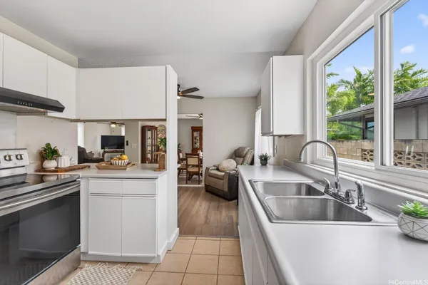 a kitchen with a sink cabinets and window