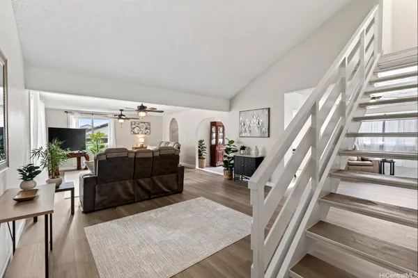 a living room with furniture and a chandelier