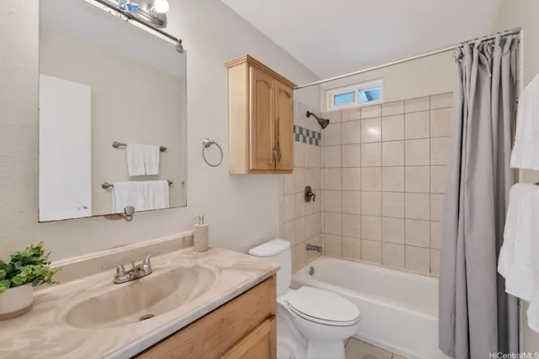 a bathroom with a sink toilet tub and shower