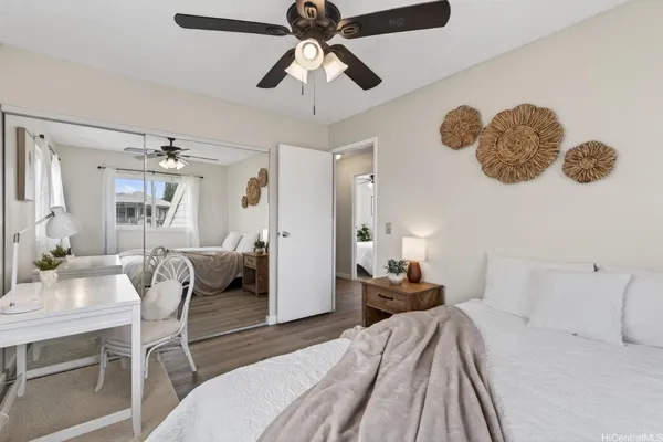 a bedroom with a bed and a chandelier