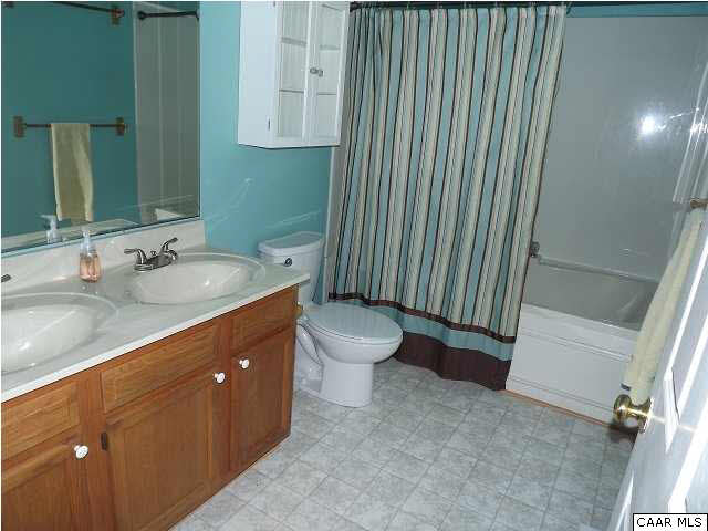 23 Dogleg Road Palmyra, VA 22963 - Photo 15 of 23 a bathroom with a granite countertop sink a toilet and a mirror