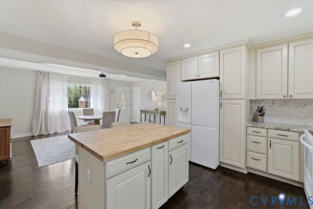 2831 Delfin Road Midlothian, VA 23112 - Photo 13 of 30 a kitchen with white cabinets and wooden floor