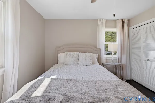 a bedroom with a large bed and a window