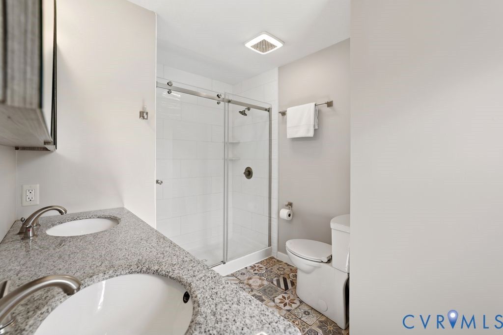 2831 Delfin Road Midlothian, VA 23112 - Photo 19 of 30 a bathroom with a granite countertop sink toilet and shower