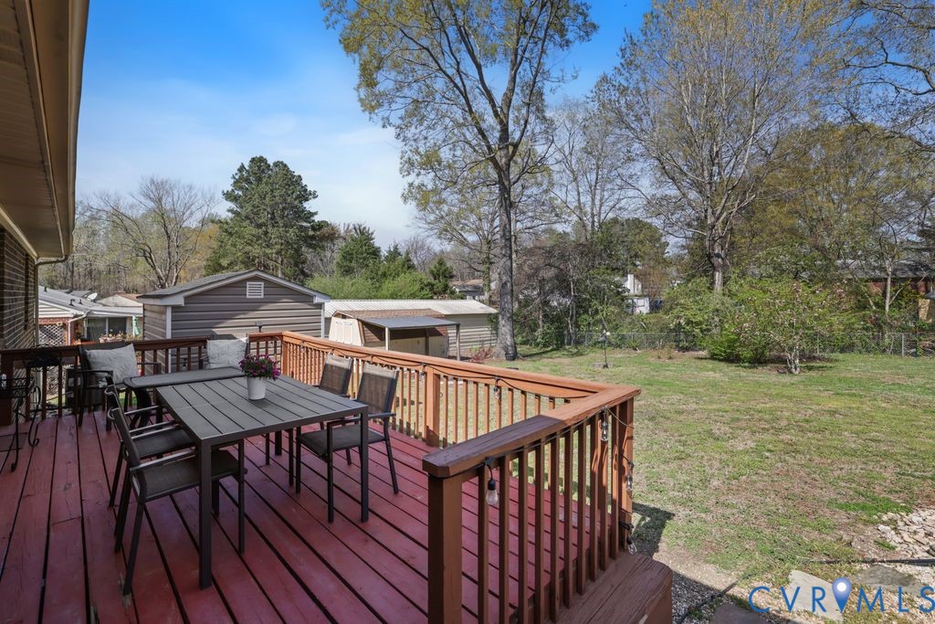2831 Delfin Road Midlothian, VA 23112 - Photo 25 of 30 a view of a roof deck with table and chairs with wooden floor and fence