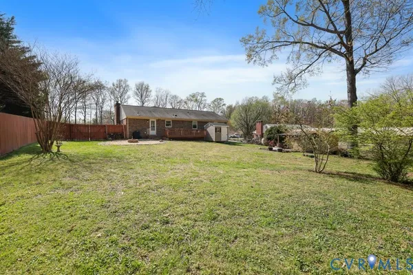 a view of a yard with a house in the background