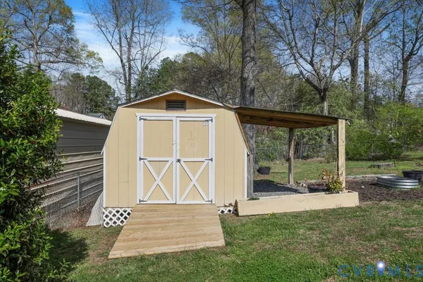 a view of wooden house with a yard