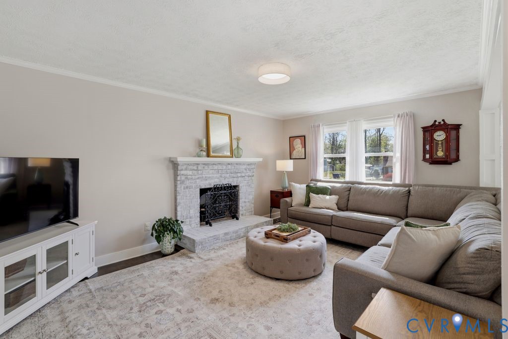 2831 Delfin Road Midlothian, VA 23112 - Photo 8 of 30 a living room with furniture a flat screen tv and a fireplace