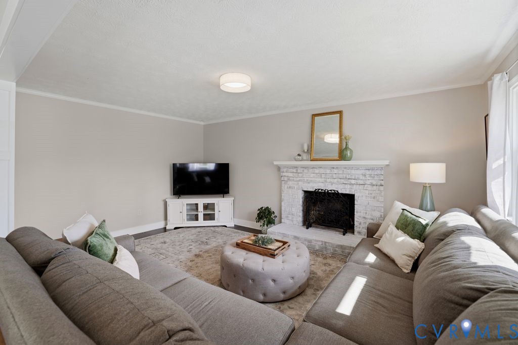 2831 Delfin Road Midlothian, VA 23112 - Photo 10 of 30 a living room with furniture and a fireplace