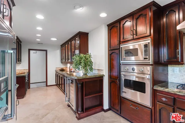a spacious bathroom with a granite countertop sink and a mirror