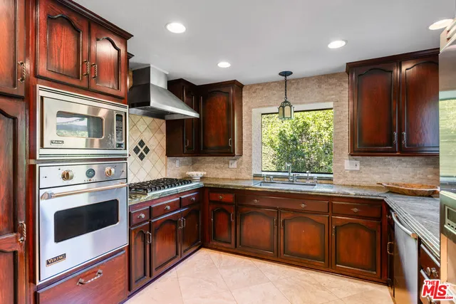 a kitchen with stainless steel appliances granite countertop a stove and a sink