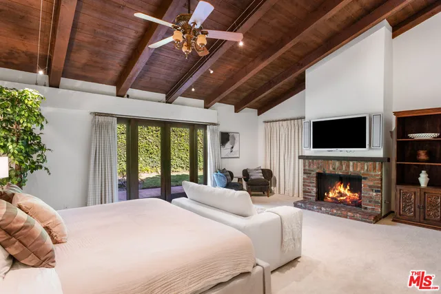 a bedroom with a bed and a fireplace