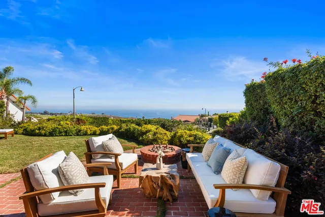 a view of a chairs and table in patio