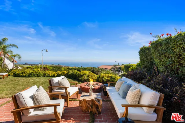 a view of a chairs and table in patio