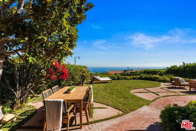 a terrace with outdoor seating and city view