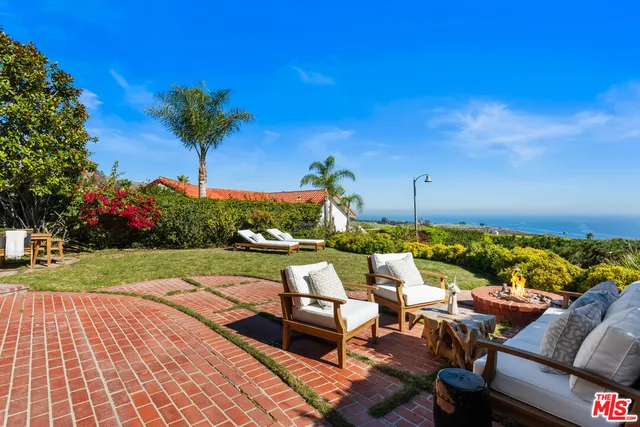 a view of a yard with a table and chairs