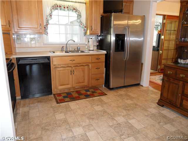 11401 Rochelle Road Chester, VA 23831 - Photo 6 of 12 a kitchen with stainless steel appliances granite countertop a sink stove and refrigerator
