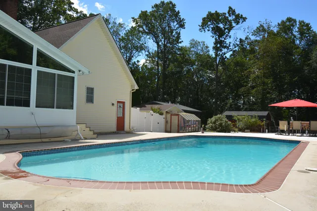 swimming pool view with a seating space