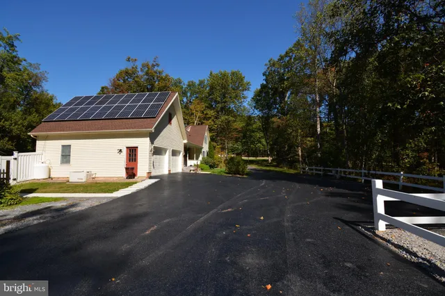 a view of a house with backyard and a garden