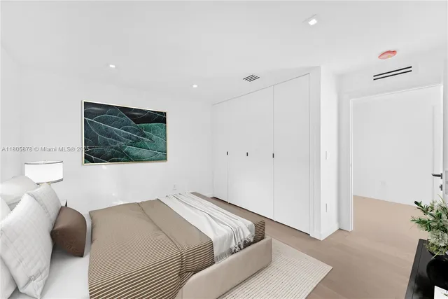 a bedroom with a bed and a painting on the wall