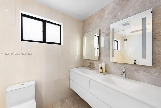 a bathroom with a double vanity sink and a mirror