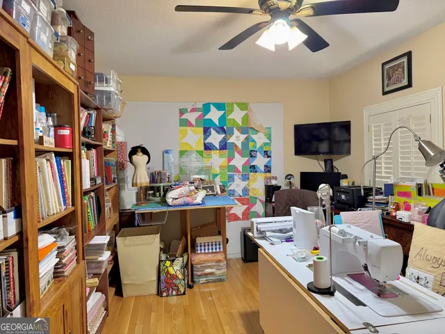 a work room with furniture and a flat screen tv