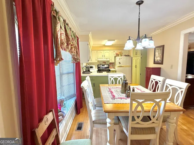 a dining room with furniture and chandelier kitchen view