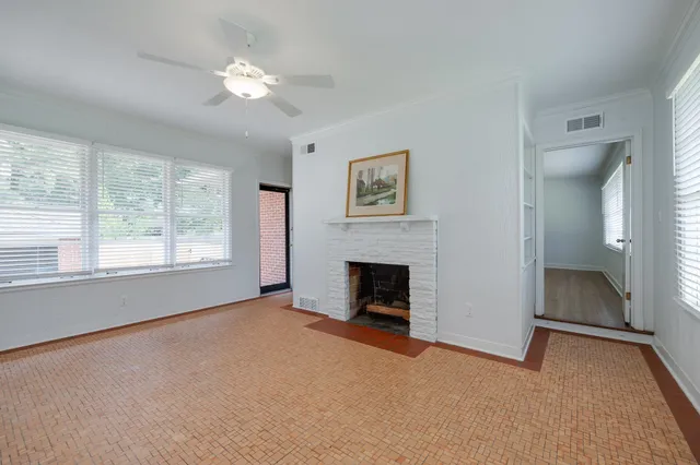 a view of empty room with a fireplace and fan