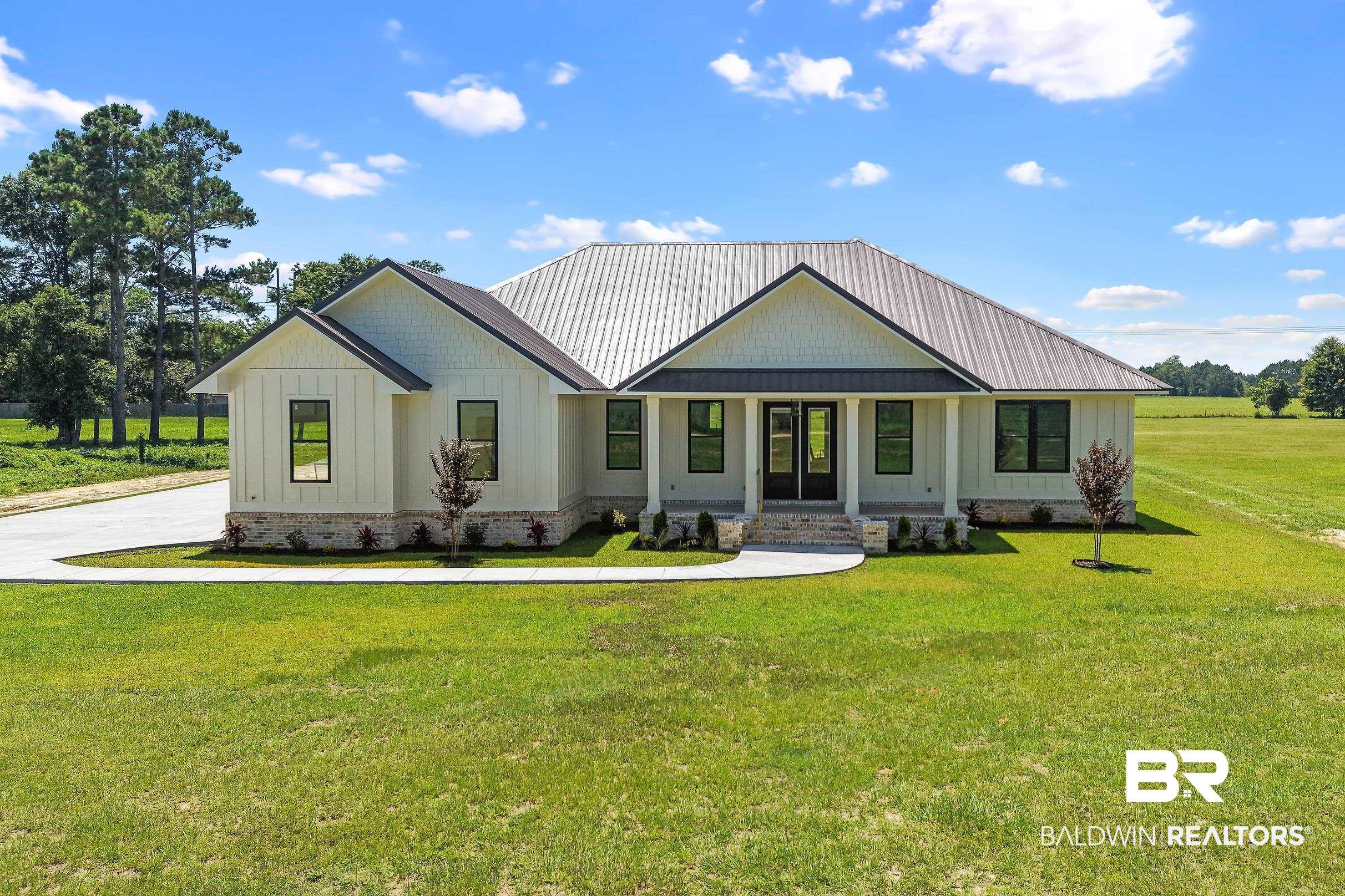 13111 Gopher Court Elberta, AL 36530 - Photo 1 of 41 Single-story residence featuring a board and batten facade and stone foundation accents
