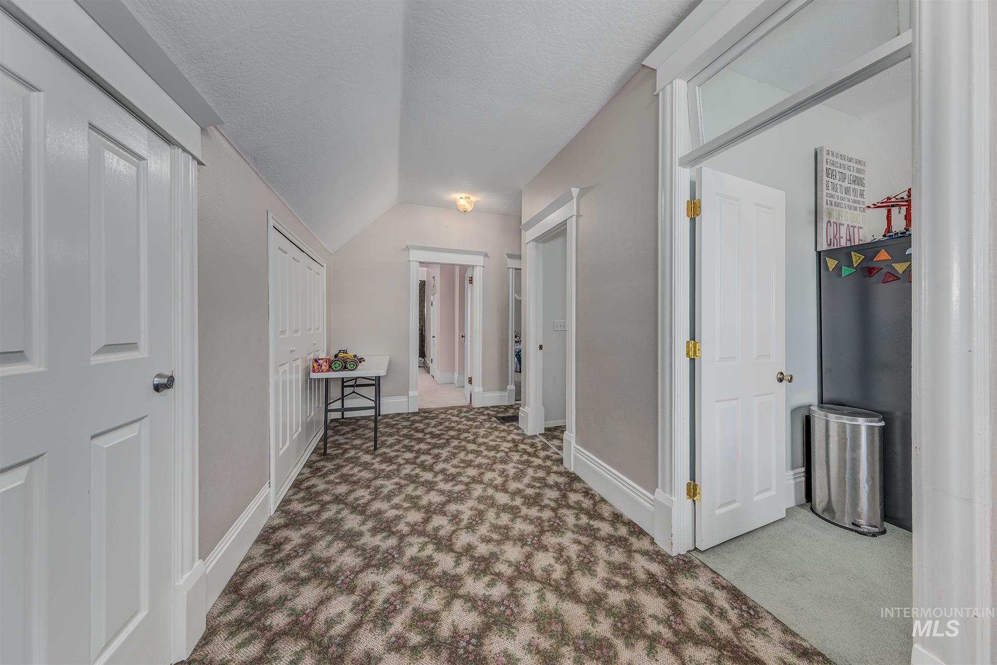 6040 Adams Road New Plymouth, ID 83655 - Photo 26 of 50 Corridor with carpet and vaulted ceiling