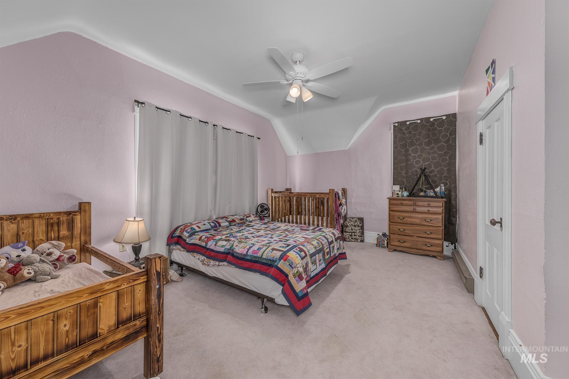 6040 Adams Road New Plymouth, ID 83655 - Photo 30 of 50 Carpeted bedroom with lofted ceiling and a ceiling fan