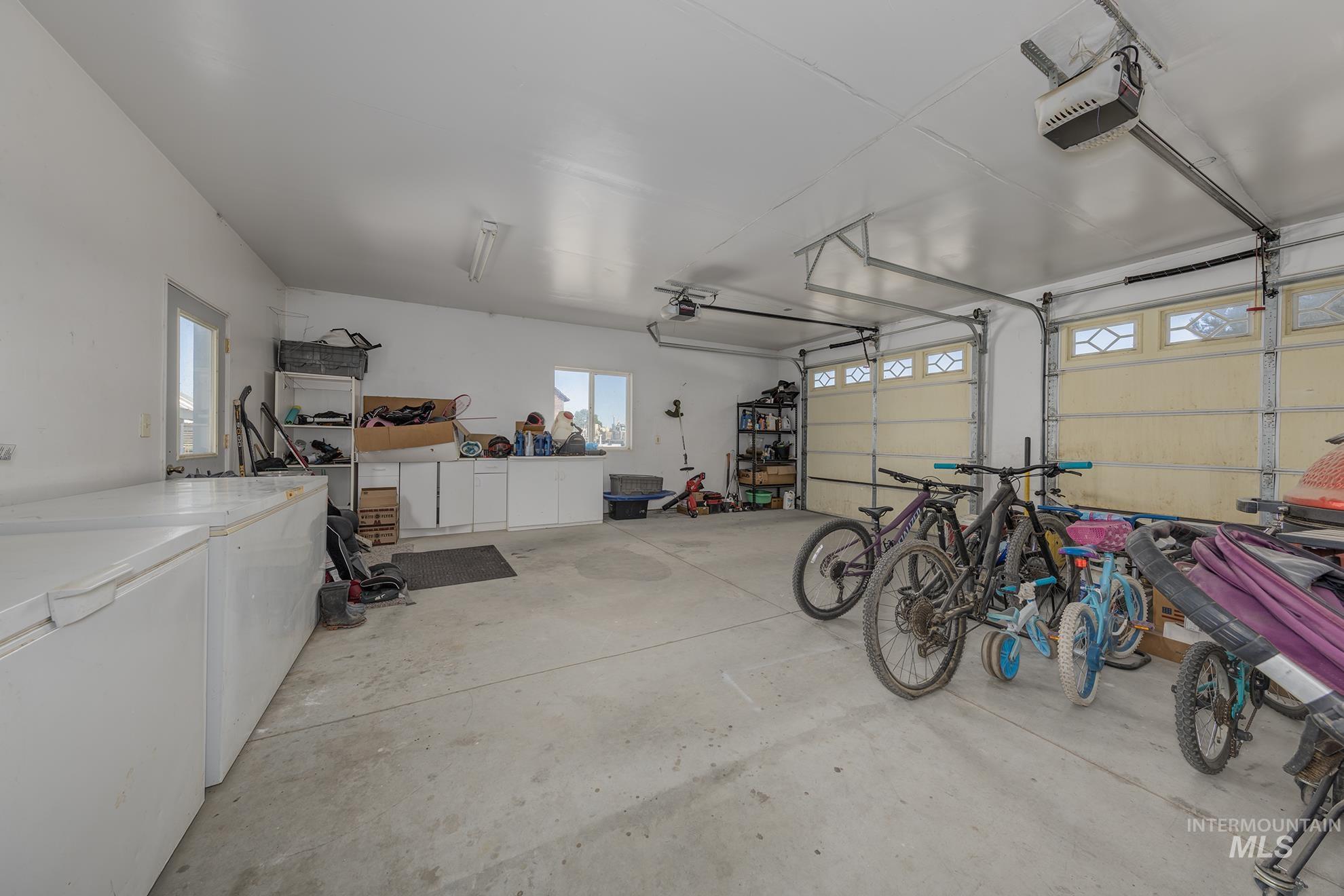 6040 Adams Road New Plymouth, ID 83655 - Photo 33 of 50 Garage featuring washer / clothes dryer and a garage door opener