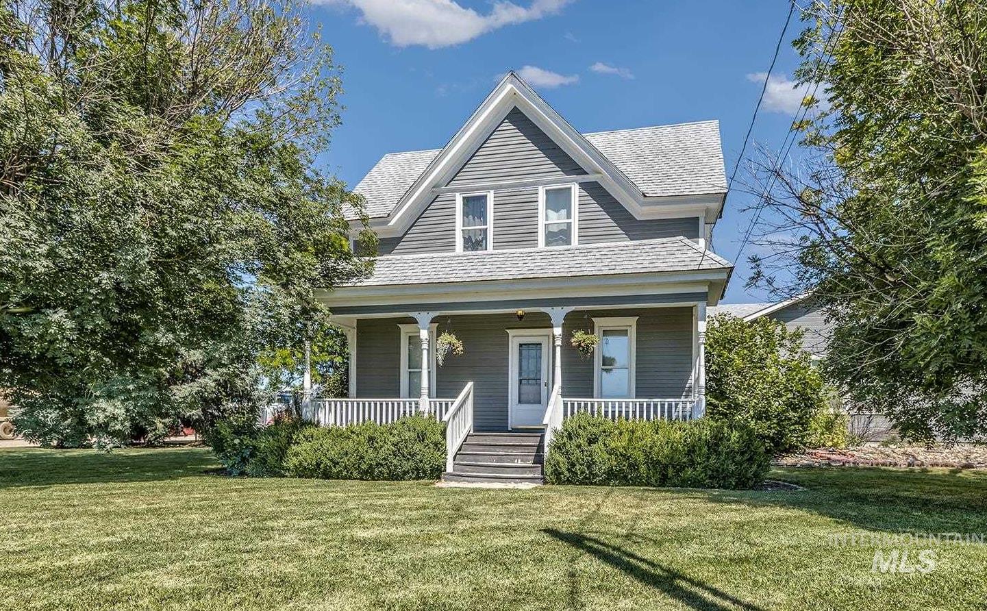 6040 Adams Road New Plymouth, ID 83655 - Photo 8 of 50 View of front of house with covered porch, a front lawn, and roof with shingles