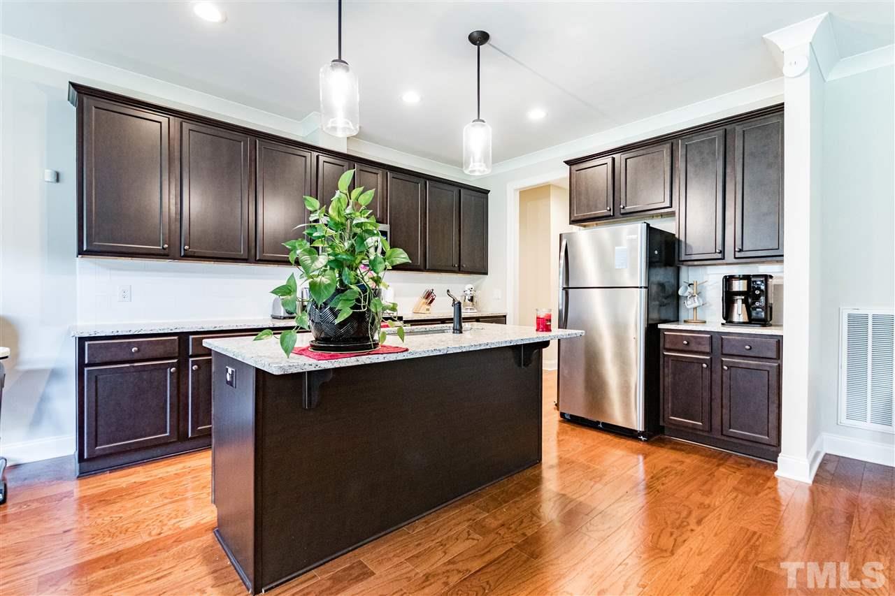 6401 Riley Hill Road Wendell, NC 27591 - Photo 13 of 23 a kitchen with kitchen island a counter top space cabinets and stainless steel appliances