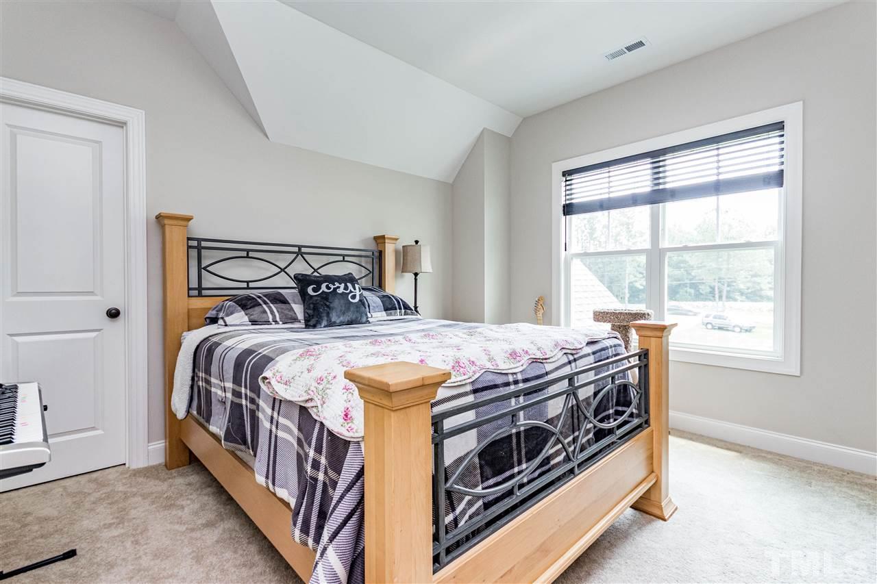 6401 Riley Hill Road Wendell, NC 27591 - Photo 16 of 23 a bedroom with a bed next to a window