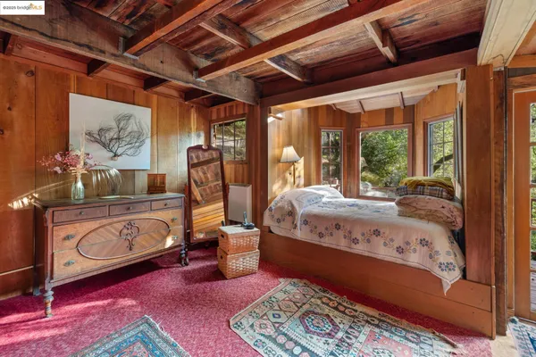 a room with lots of furniture and a potted plant