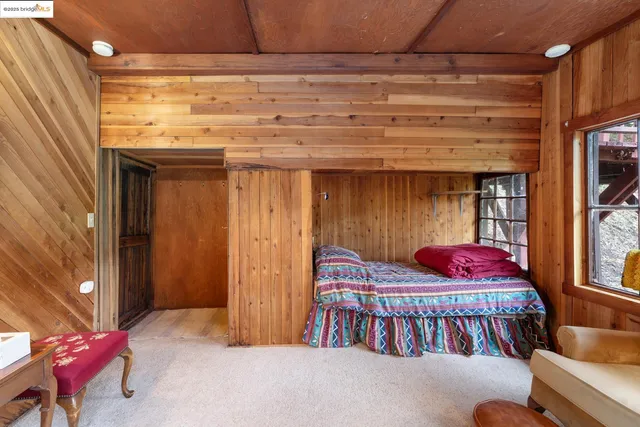 a view of a house with a tree in front of it