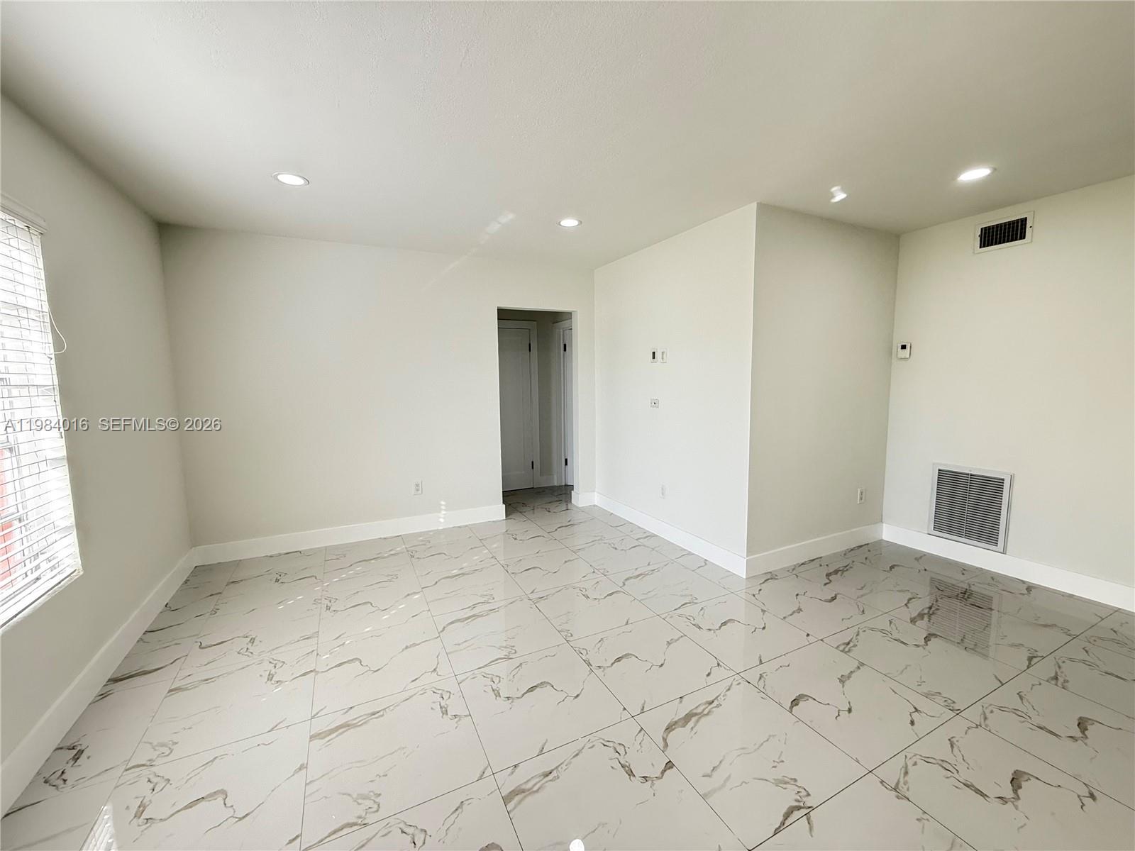 617 Southwest 11th Street, Unit 14E Miami, FL 33129 - Photo 3 of 16 a view of hallway with a window and chandelier