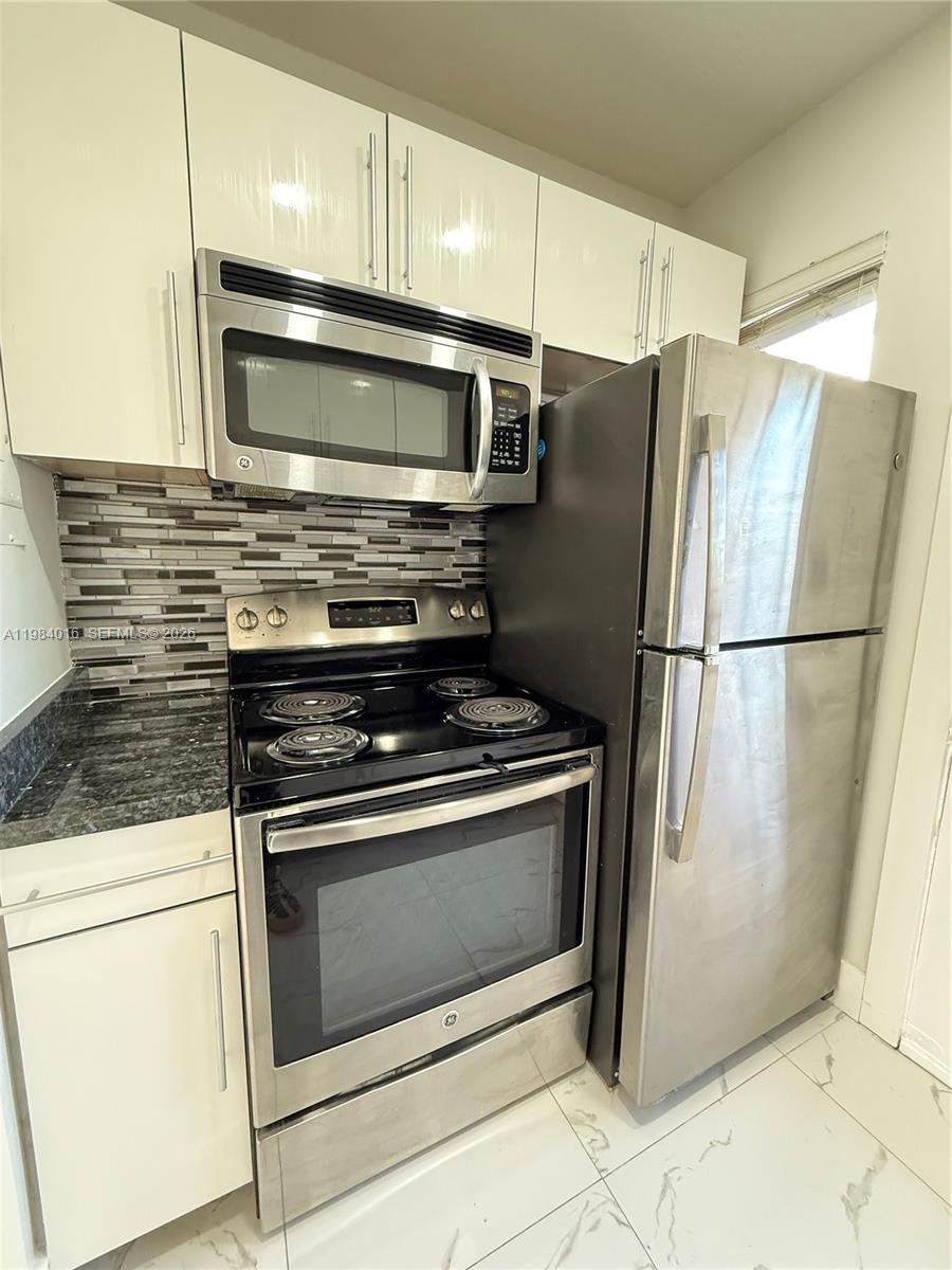 617 Southwest 11th Street, Unit 14E Miami, FL 33129 - Photo 6 of 16 a kitchen with appliances and cabinets