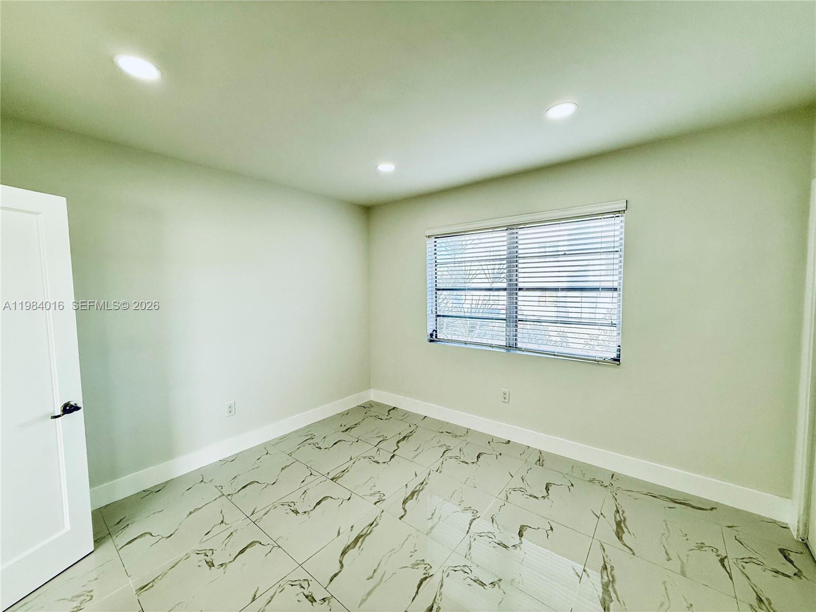 617 Southwest 11th Street, Unit 14E Miami, FL 33129 - Photo 9 of 16 an empty room with a window