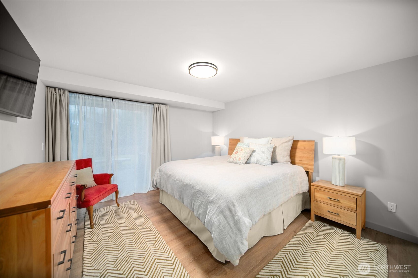 1535 Castlerock Avenue, Unit 26 Wenatchee, WA 98801 - Photo 11 of 32 a bedroom with a bed and wooden floor