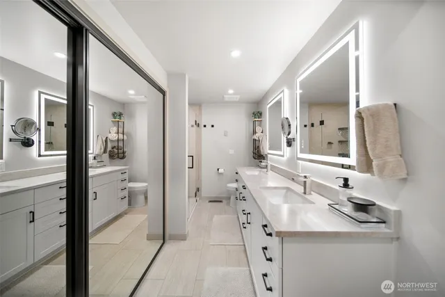 a spacious bathroom with a shower sink and mirror