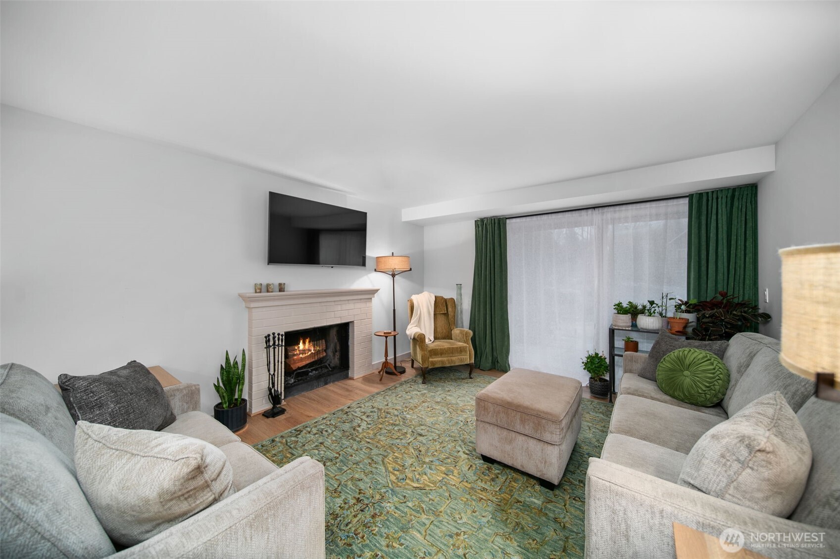 1535 Castlerock Avenue, Unit 26 Wenatchee, WA 98801 - Photo 3 of 32 a living room with furniture a fireplace and a flat screen tv