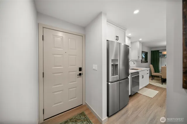 a kitchen with a refrigerator and a sink