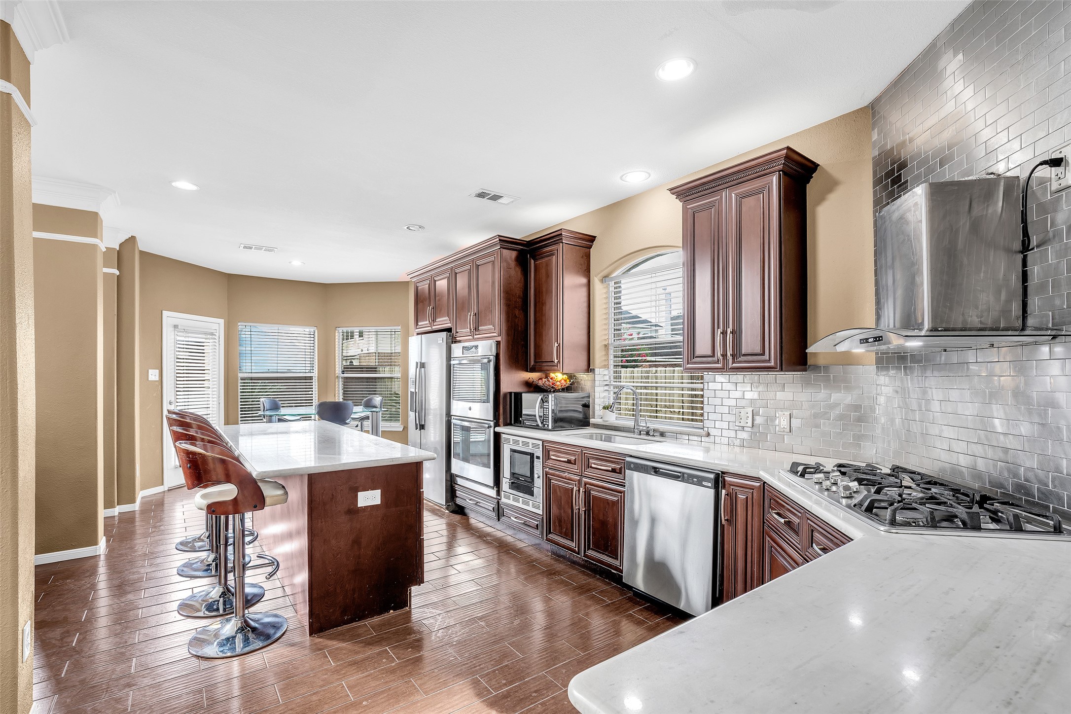 611 River Delta Lane Rosenberg, TX 77469 - Photo 19 of 39 a kitchen with stainless steel appliances kitchen island granite countertop a sink stove and refrigerator