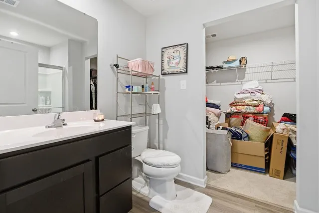 a bathroom with a sink toilet and a mirror