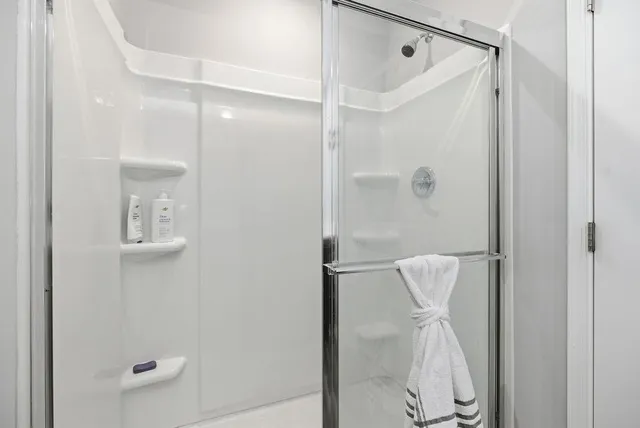 a bathroom with a shower and a mirror
